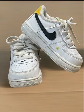 Nike Toddler White Sneakers with Black Swoosh and Yellow Star